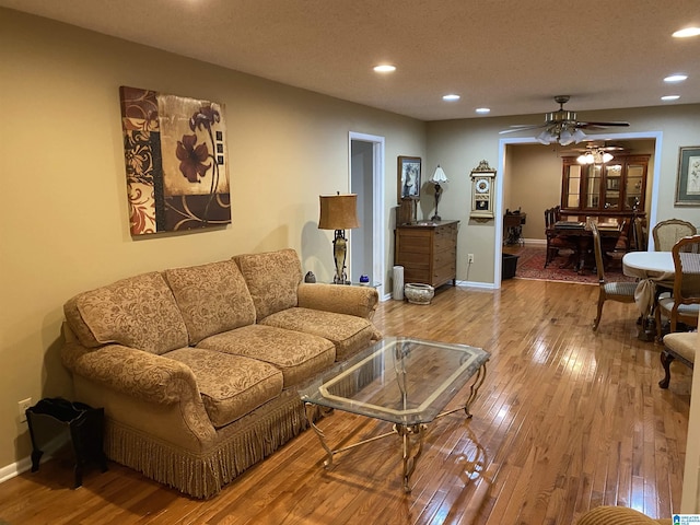 living room with baseboards, hardwood / wood-style floors, and recessed lighting