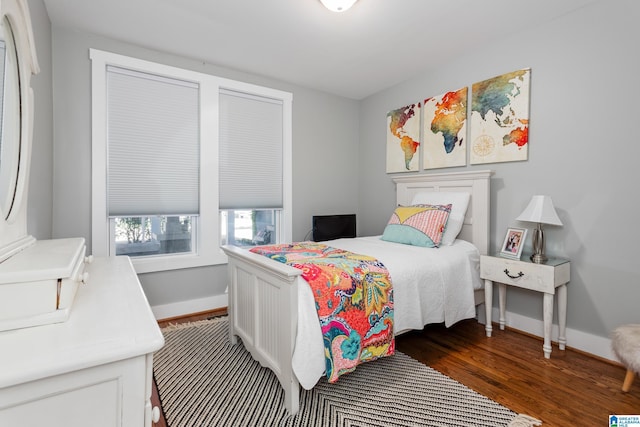 bedroom with dark wood-style floors and baseboards