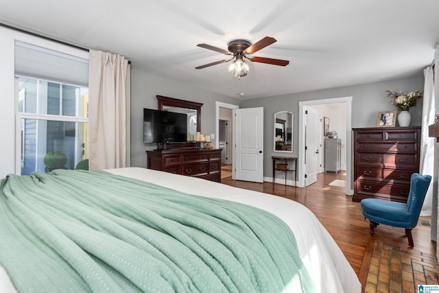 bedroom with a ceiling fan, dark wood-style flooring, and baseboards