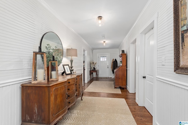 entryway featuring ornamental molding and wood finished floors