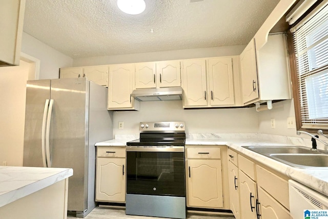 kitchen featuring light countertops, appliances with stainless steel finishes, a sink, and under cabinet range hood