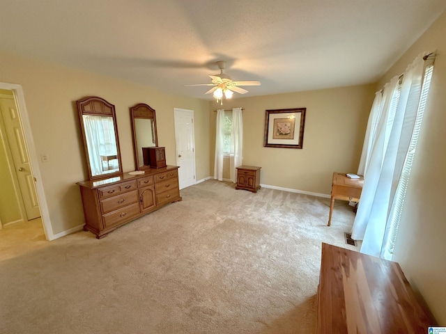 bedroom featuring light carpet, multiple windows, and baseboards