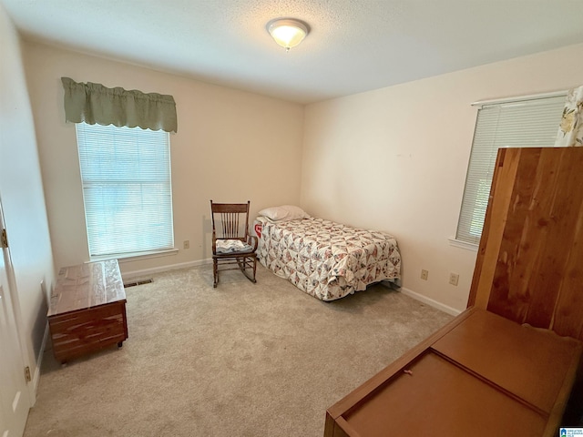 bedroom with carpet flooring, visible vents, and baseboards