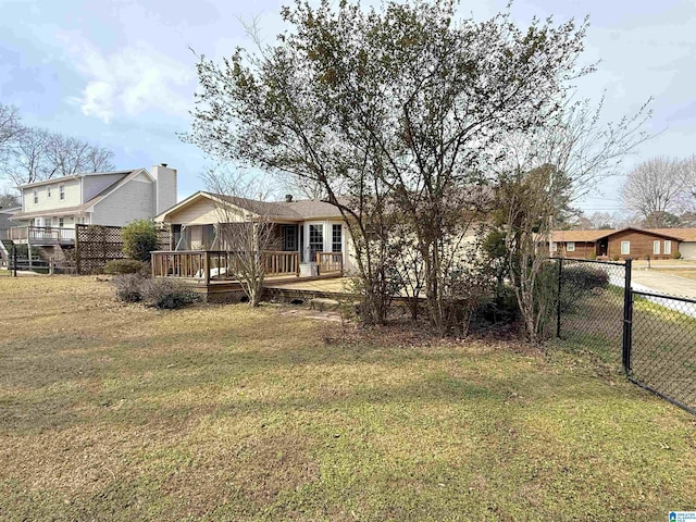 view of yard featuring fence and a wooden deck