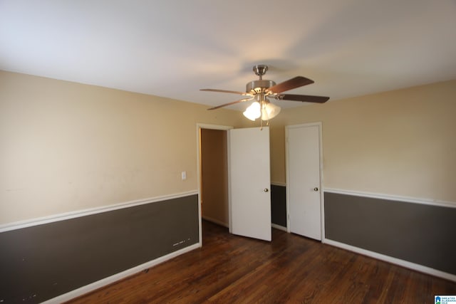 unfurnished bedroom with ceiling fan, wood finished floors, and baseboards