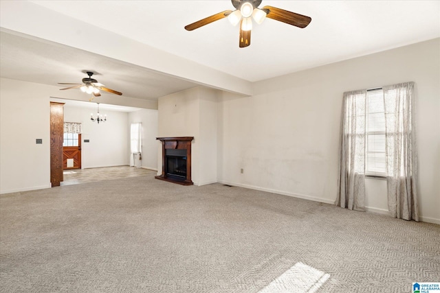65 Jessica Dr, Wedowee, AL 36278 - unfurnished living room featuring light carpet, a fireplace with raised hearth, ceiling fan with notable chandelier, and baseboards