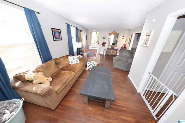 living area with baseboards and wood finished floors