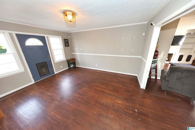 entrance foyer with a textured ceiling, a fireplace, wood-type flooring, and baseboards