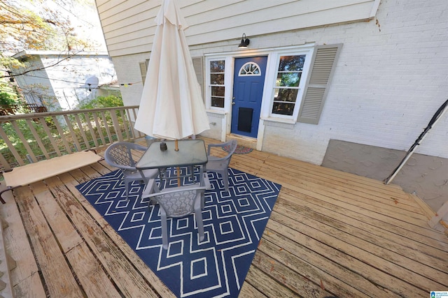 wooden terrace featuring outdoor dining area