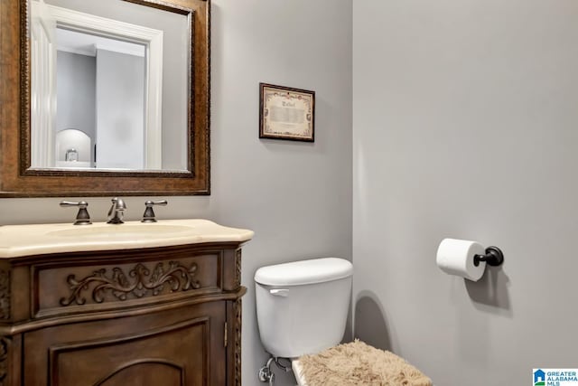 bathroom featuring toilet and vanity