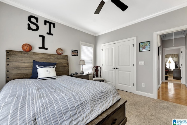 bedroom featuring carpet floors, baseboards, a closet, attic access, and crown molding