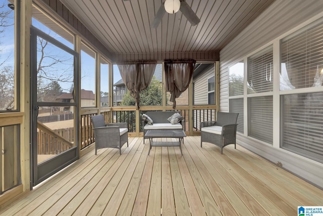 unfurnished sunroom with ceiling fan and wood ceiling