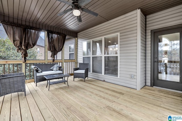 wooden deck with a ceiling fan and outdoor lounge area