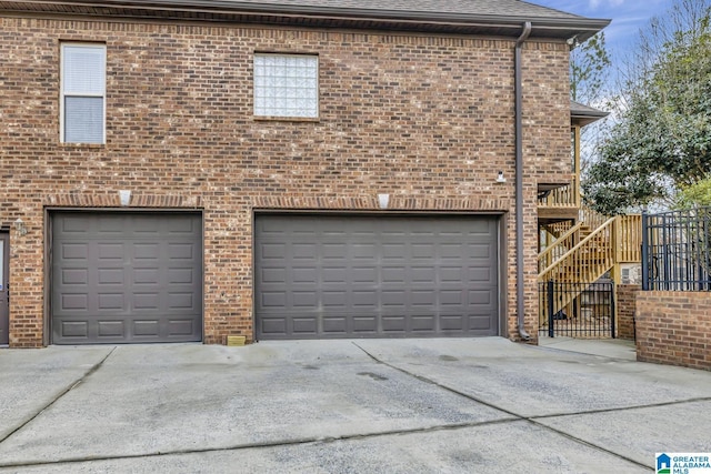 garage featuring concrete driveway