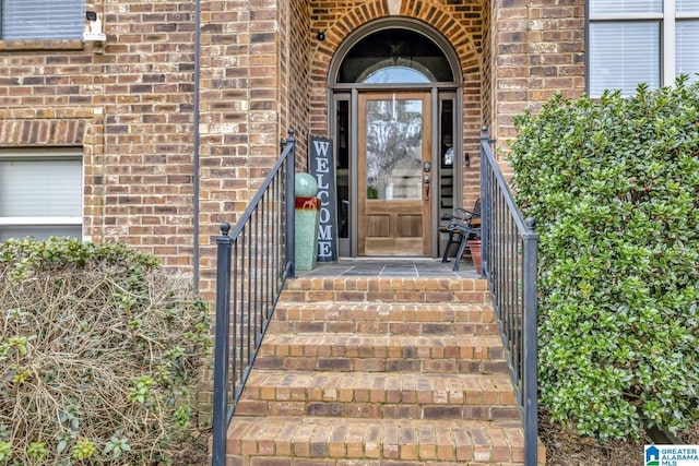 entrance to property with brick siding