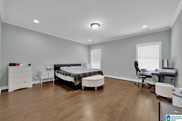 bedroom featuring visible vents, baseboards, ornamental molding, recessed lighting, and wood finished floors