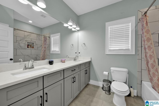 bathroom featuring a sink, visible vents, baseboards, and toilet