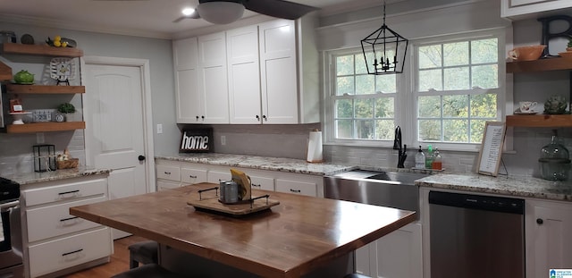 kitchen featuring butcher block countertops, white cabinetry, stainless steel dishwasher, backsplash, and open shelves