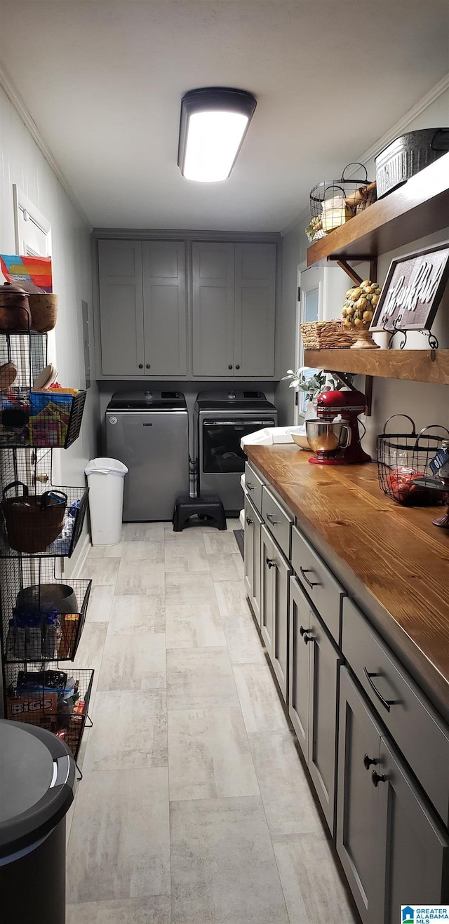 kitchen featuring butcher block countertops, washer and dryer, gray cabinets, and fridge