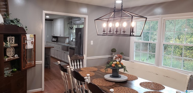 dining area featuring a chandelier and dark wood-type flooring