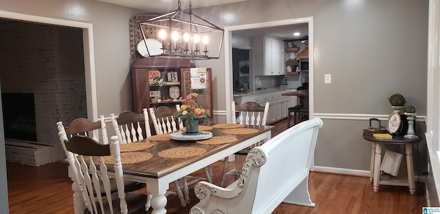 dining space featuring a chandelier and wood finished floors