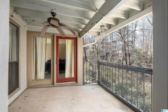 view of patio with a ceiling fan and a balcony