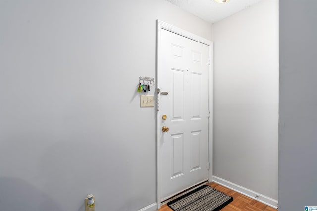 doorway featuring baseboards