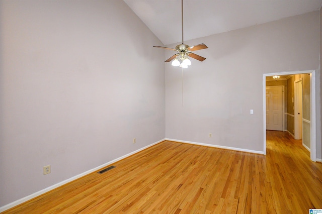 spare room featuring lofted ceiling, ceiling fan, visible vents, baseboards, and light wood-type flooring