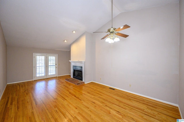 unfurnished living room featuring a fireplace with raised hearth, visible vents, light wood-style flooring, and baseboards