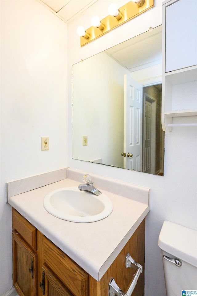 bathroom with toilet and vanity