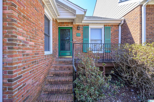 property entrance featuring brick siding