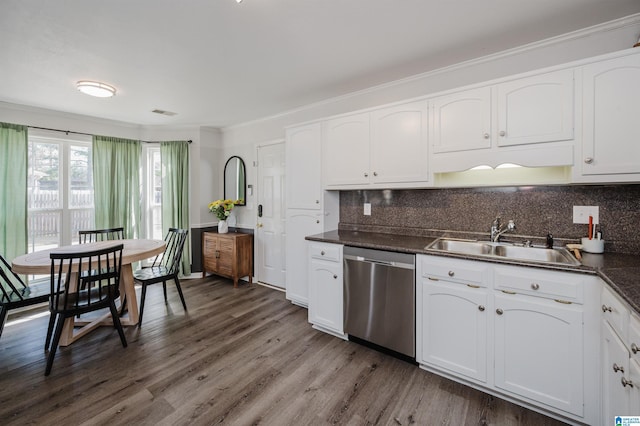 kitchen with white cabinets, dishwasher, dark countertops, wood finished floors, and a sink