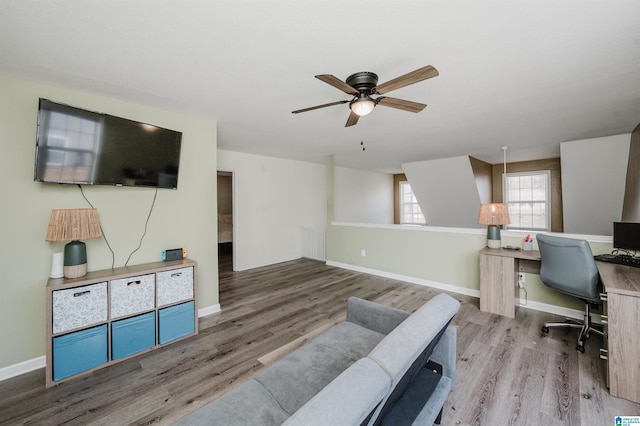 office space with a ceiling fan, baseboards, and wood finished floors