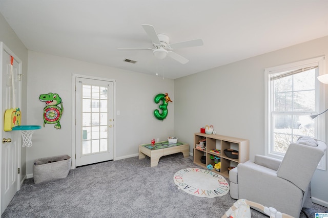 recreation room with baseboards, a healthy amount of sunlight, visible vents, and carpet flooring