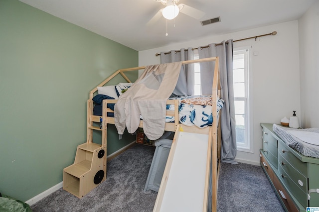 carpeted bedroom with baseboards, visible vents, and a ceiling fan