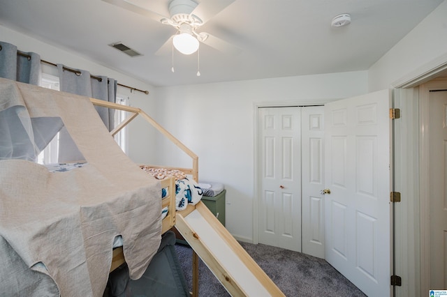 bedroom featuring carpet floors, ceiling fan, visible vents, and a closet