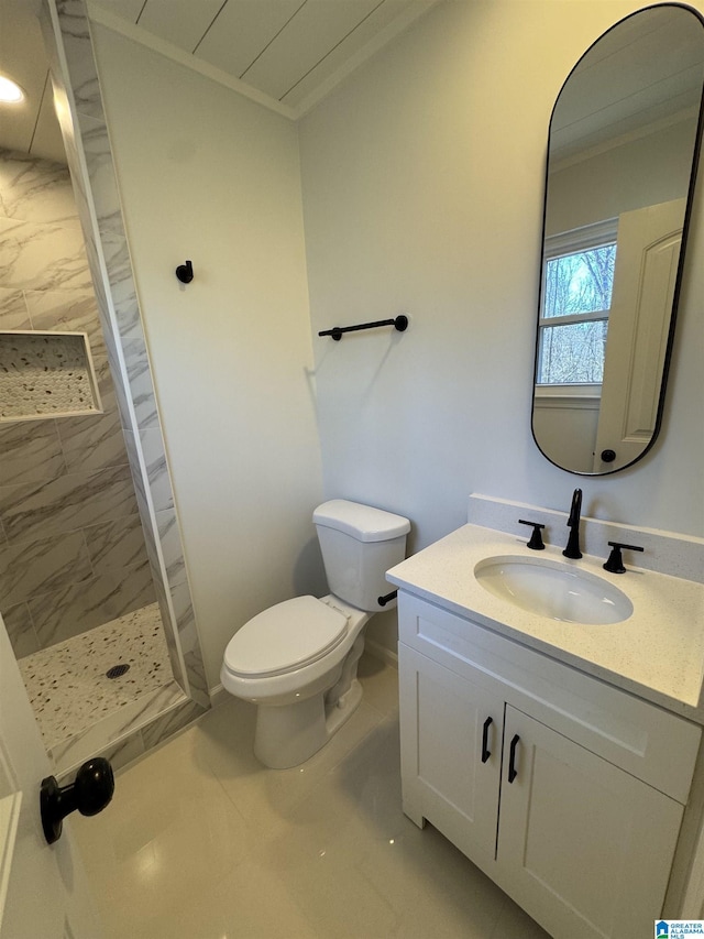 bathroom featuring ornamental molding, a stall shower, vanity, and toilet