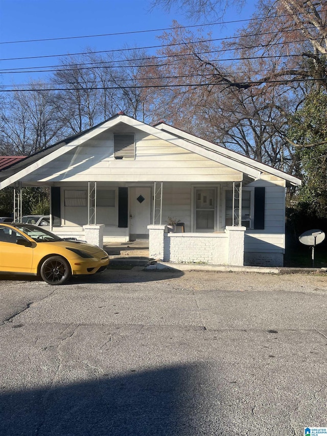 bungalow with a porch and a carport