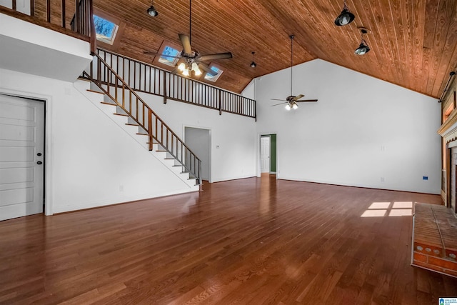 unfurnished living room featuring wooden ceiling, stairs, high vaulted ceiling, and wood finished floors