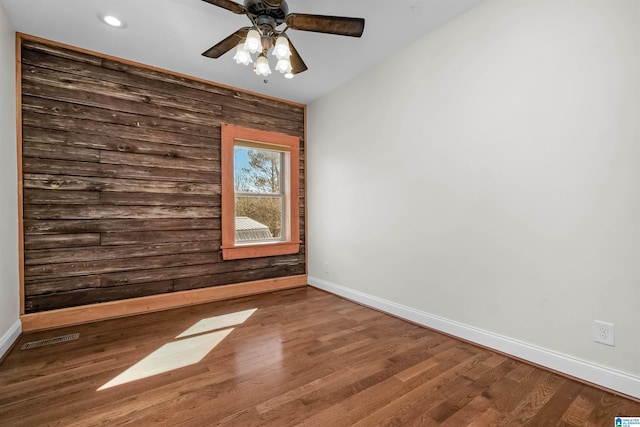 unfurnished room featuring ceiling fan, recessed lighting, wood finished floors, visible vents, and baseboards