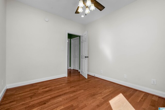 empty room featuring a ceiling fan, light wood-style flooring, and baseboards