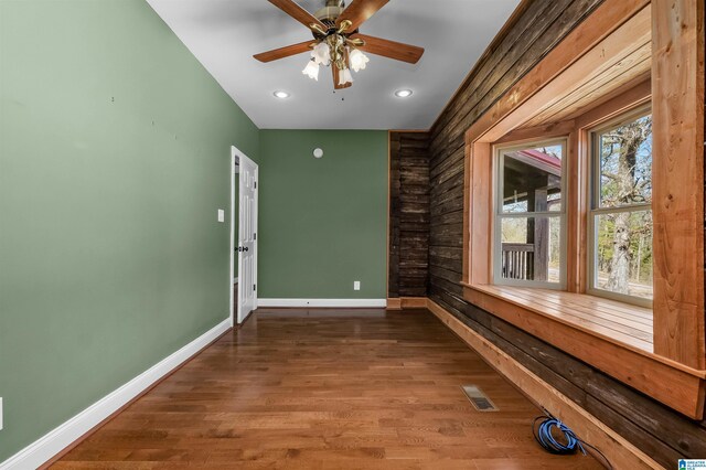 empty room with recessed lighting, visible vents, baseboards, and wood finished floors