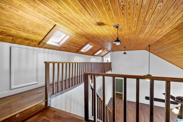 bonus room with wood ceiling, vaulted ceiling with skylight, and wood finished floors