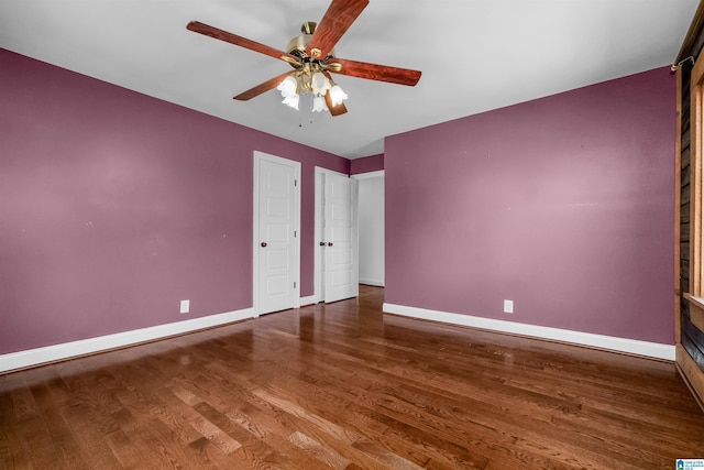 unfurnished bedroom with ceiling fan, baseboards, and wood finished floors