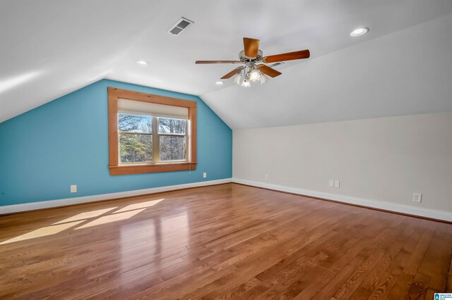 bonus room featuring baseboards, visible vents, and wood finished floors