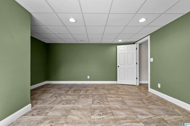 finished basement featuring recessed lighting, a paneled ceiling, and baseboards