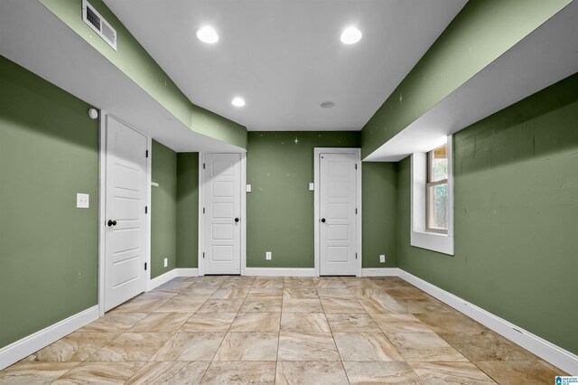 below grade area with recessed lighting, visible vents, and baseboards