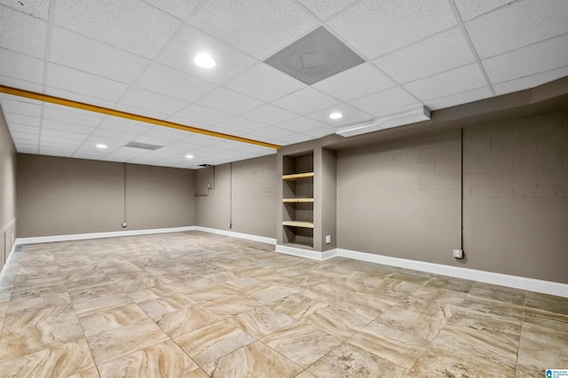 finished basement with recessed lighting, a drop ceiling, and baseboards