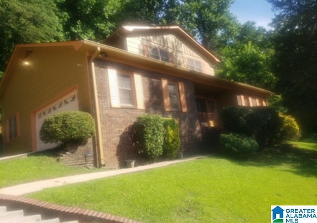 view of side of property with brick siding and a yard