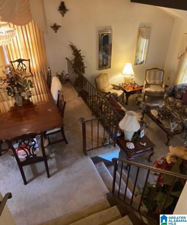 interior space featuring carpet floors, stairway, and beam ceiling